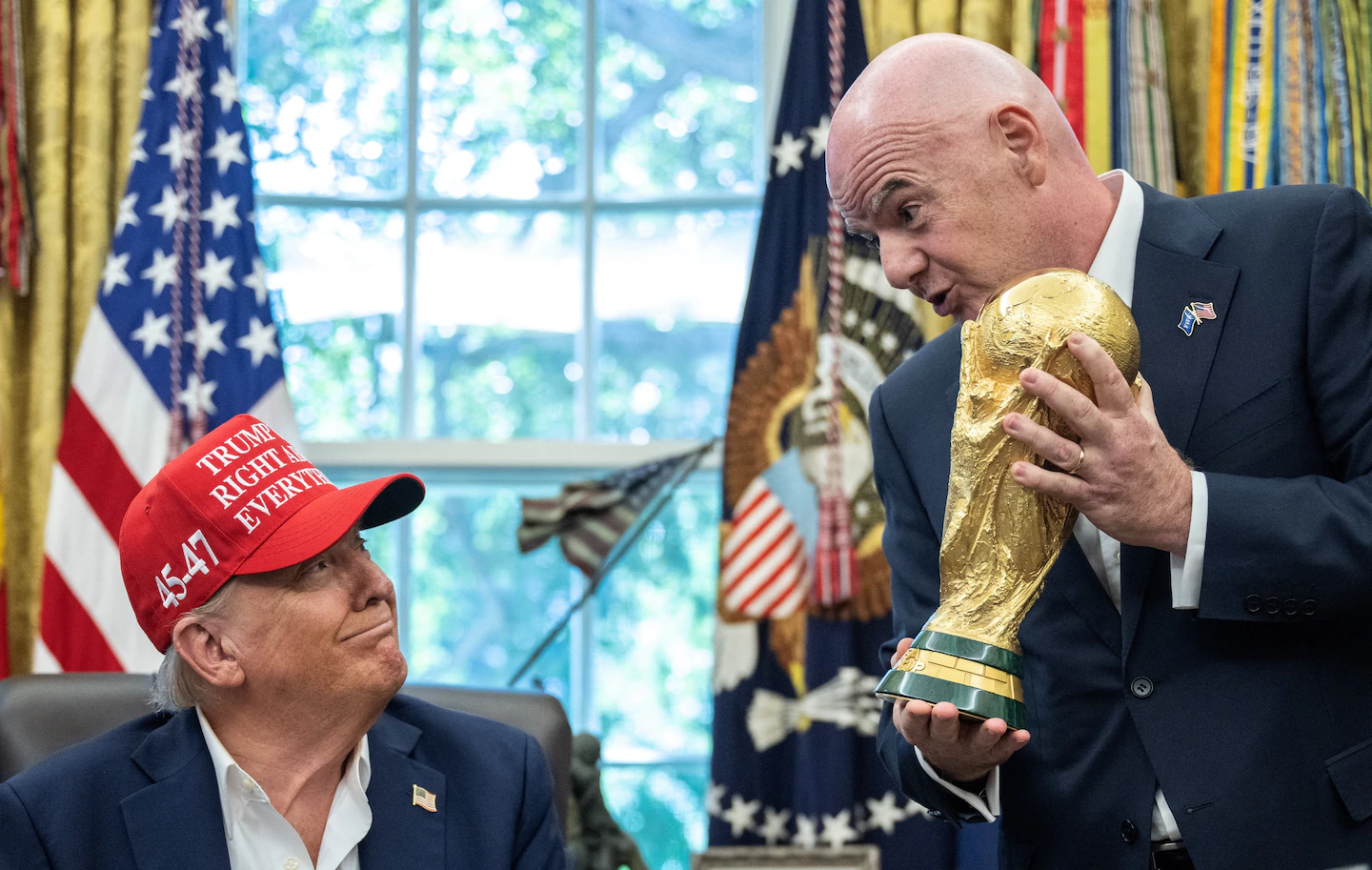 FIFA president Gianni Infantino hands the World Cup trophy to U.S. President Donald Trump in the Oval Office on Aug.22
