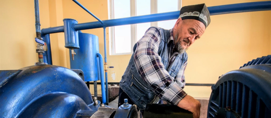 A technician services the machinery at a renovated irrigation pumping station in Tajikistan.