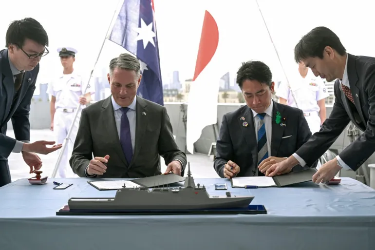 Australian Defence Minister Richard Marles and Japanese Defence Minister Koizumi Shinjiro sign a memorandum in Melbourne, Australia, on April 18, 2026