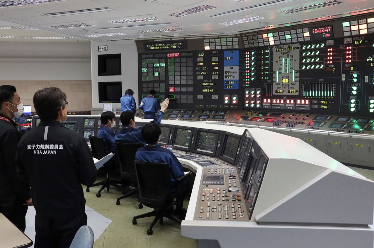 Workers sit in front of a nuclear power plant central control room for the Tokyo Electric Power Company Kashiwazaki-Kariwa on January 21, 2026