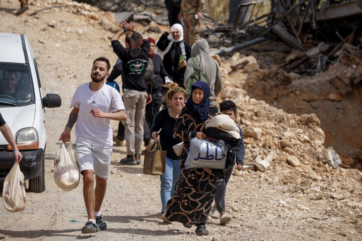 Displaced people make their way back to their home crossing the bridge linking southern Lebanon to the rest of the country, which was hit earlier in an Israeli strike, after a ten-day ceasefire between Lebanon and Israel went into effect, in Qasmiyeh, Lebanon, April 17, 2026.